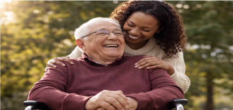 Caregiver with senior smiling outdoors